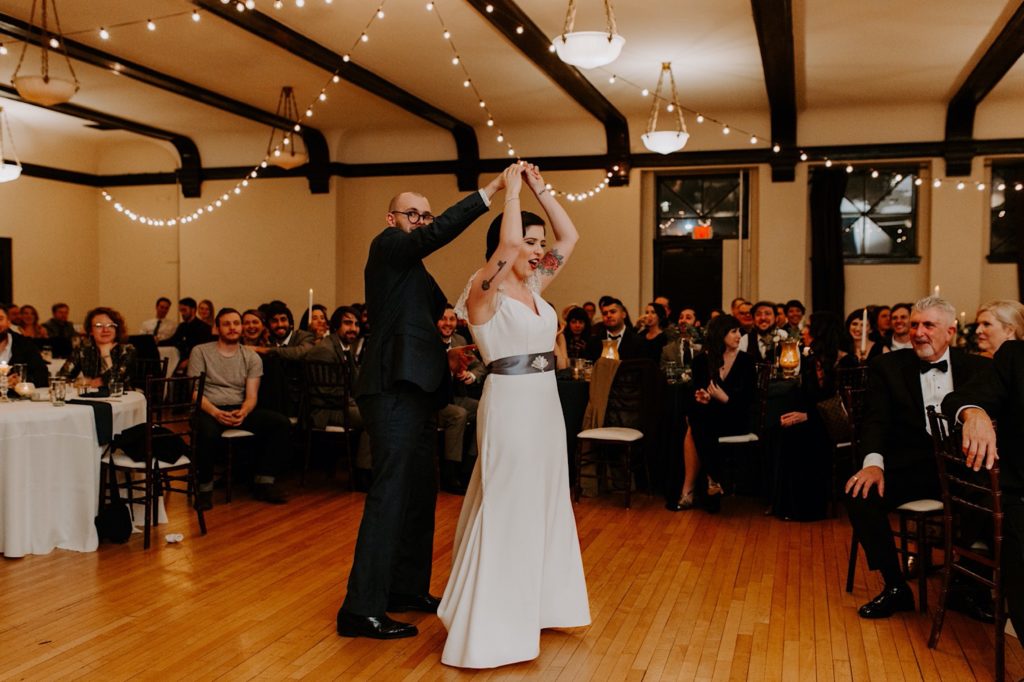 bride and groom having fun during their first dance at the Asheville  masonic temple