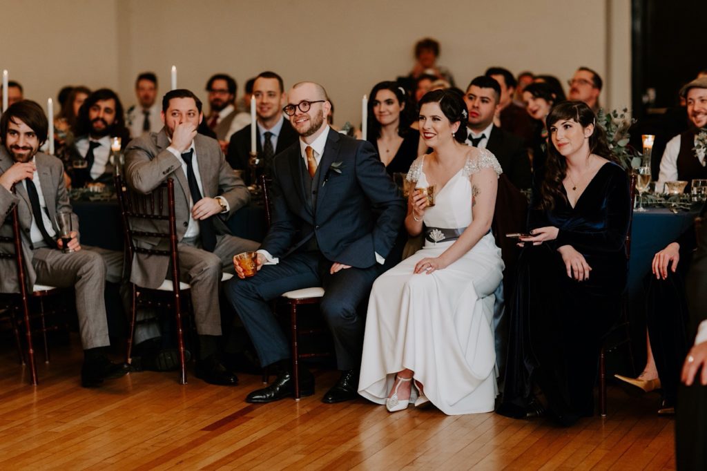 bride and groom listening to speech by the best man at the Asheville  masonic temple