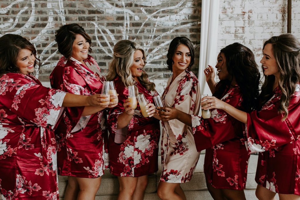 bridesmaids drinking mimosas at Greensboro wedding venue